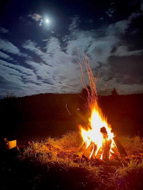 A bonfire under the light of the moon. 