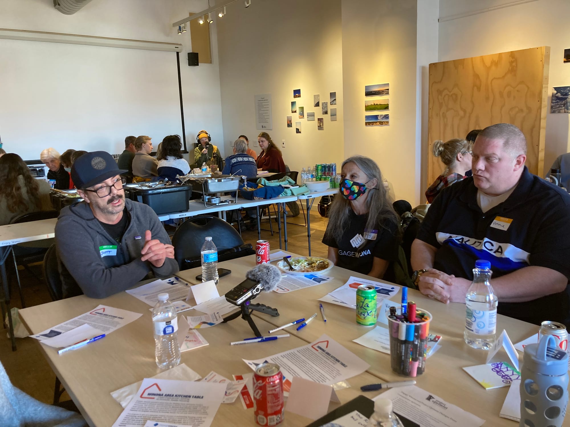 People listen to a man speak at a moderated dialogue event.