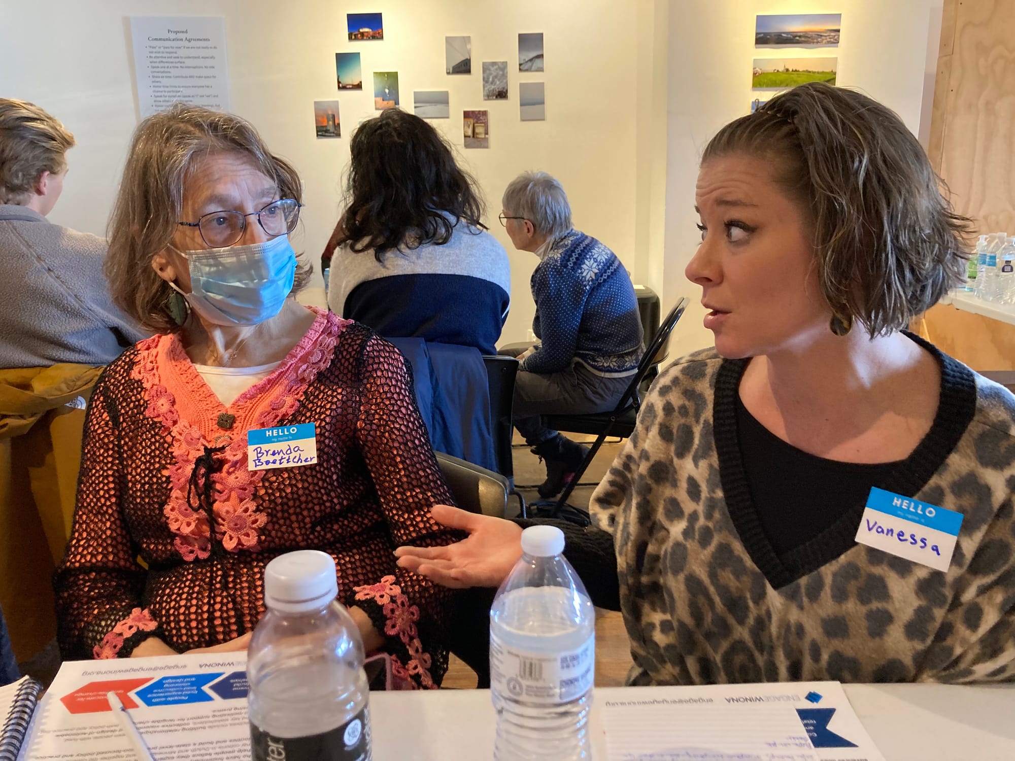 One woman talks while another listens closely during a dialogue event. 