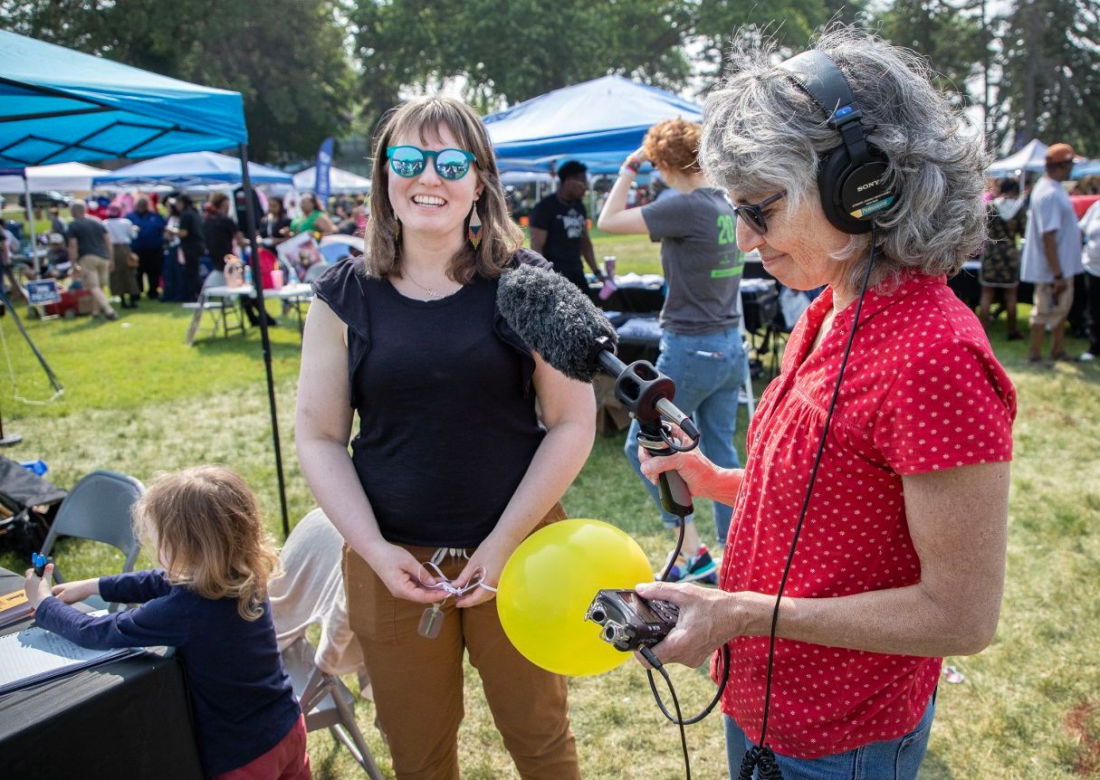 Photo of Project Optimist founder Nora Hertel talking with audio journalist Laurie Stern at the St. Cloud Juneteenth festival on June 16, 2023. 