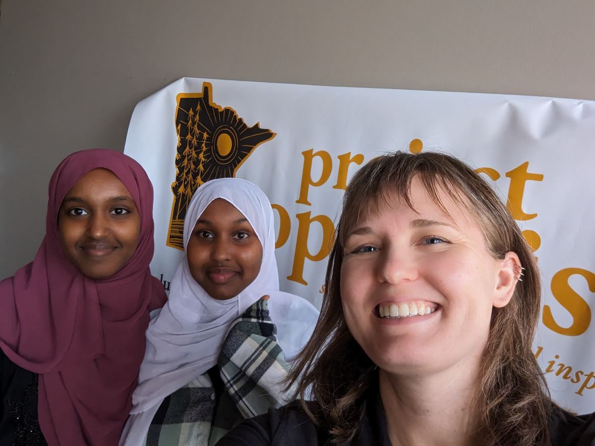 Project Optimist founder Nora Hertel with high school seniors Ifrah (left) and Rahma (center) after a Journalism 101 training in St. Cloud on June 20, 2023.