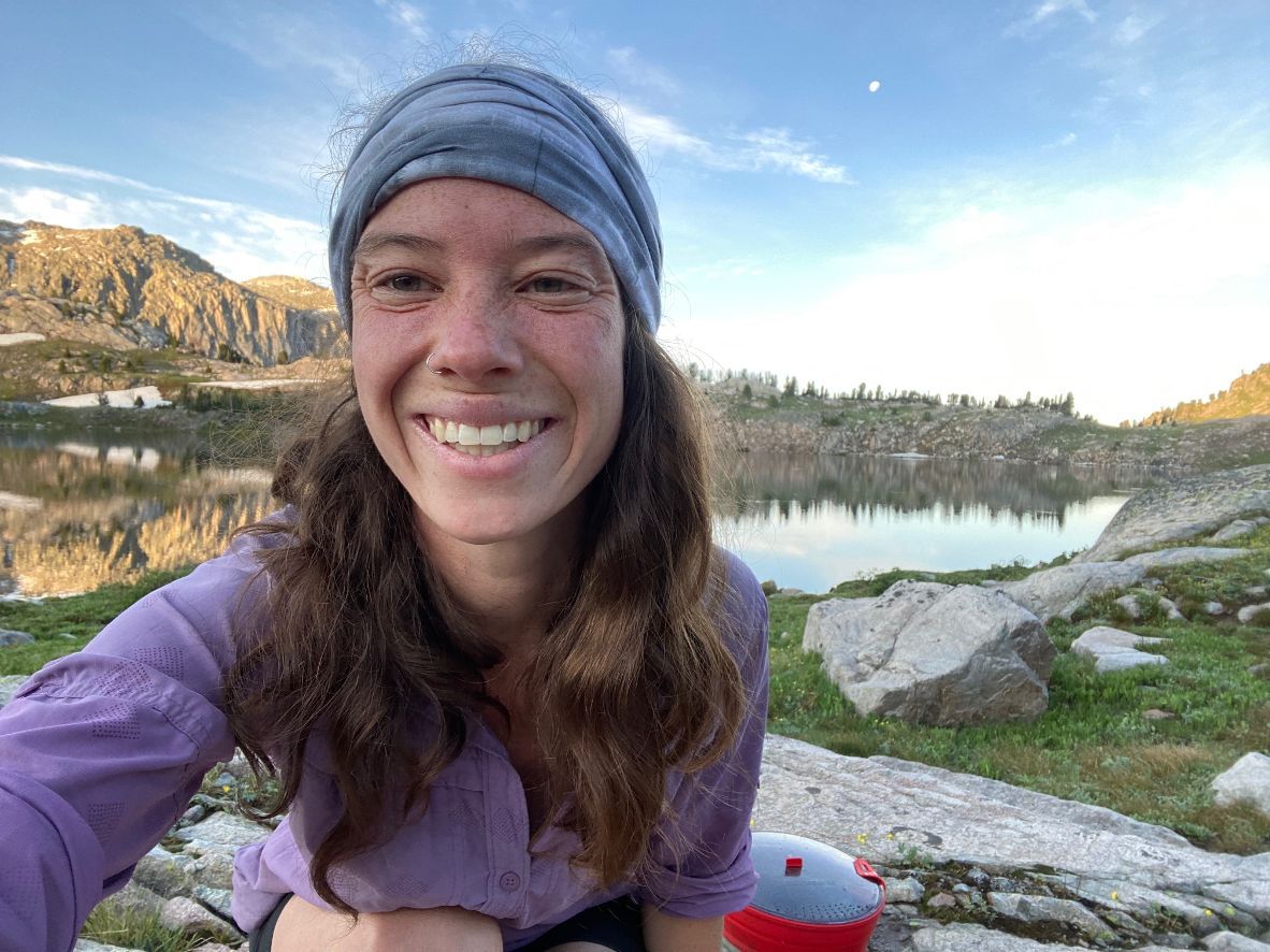 Photo of Janelle Bradley wearing a winter hat and coat and glasses