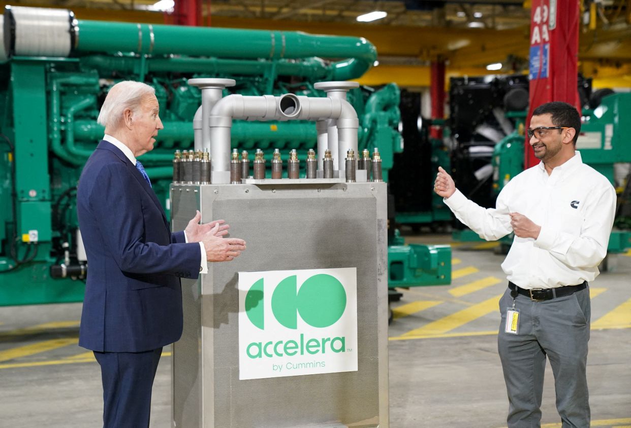U.S. President Joe Biden speaks with an employee as he tours the Cummins Power Generation Facility in Fridley, Minnesota, U.S., April 3, 2023.