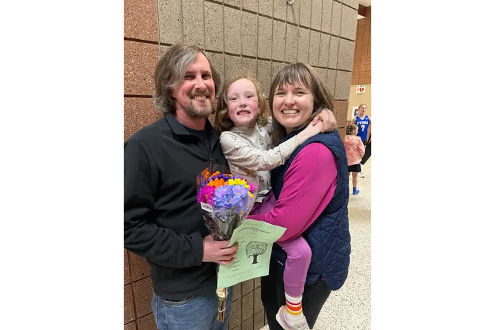 A family poses for a portrait. 