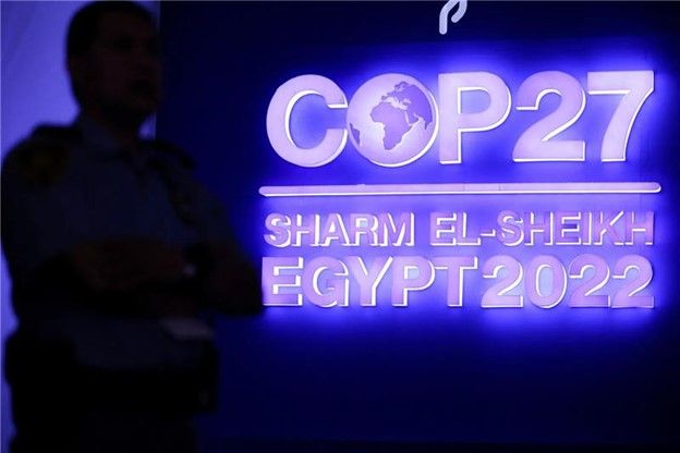 A security personnel stands guard next to the COP27 sign during the closing plenary at the COP27 climate summit in Red Sea re