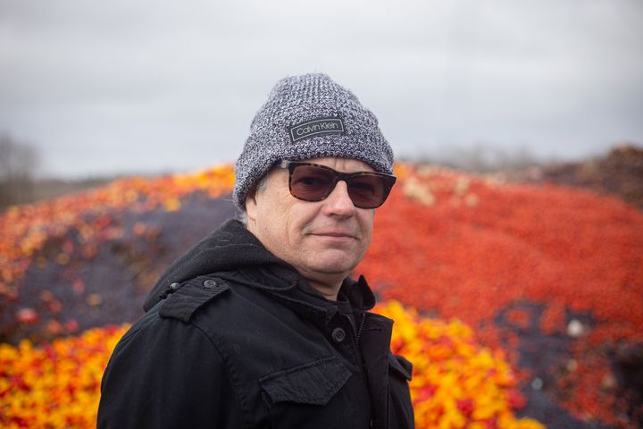 Walter Ribeiro, founder of The Dragonfly-e Inc., stands in front of a compost pile at the Wadena County Recycling Center and