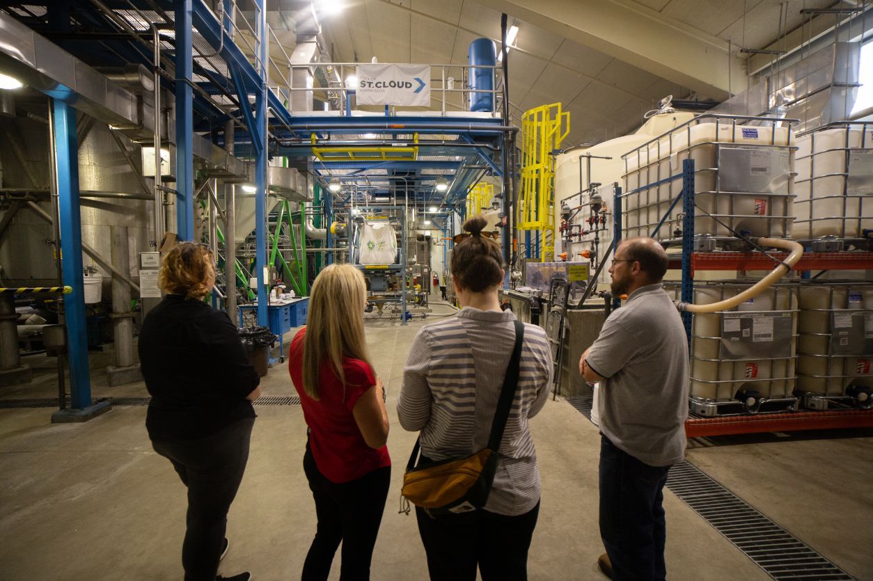 Reporter Nora Hertel (third from left) learns about struvite with three staff at the St. Cloud NEW Recovery Facility on Monday, June 13, 2022. (Shannon Rathmanner for Project Optimist)